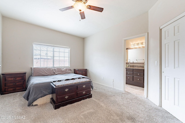 bedroom featuring carpet floors, ceiling fan, baseboards, and connected bathroom