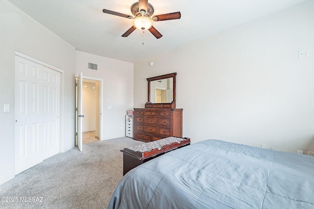carpeted bedroom featuring a closet, a ceiling fan, and visible vents