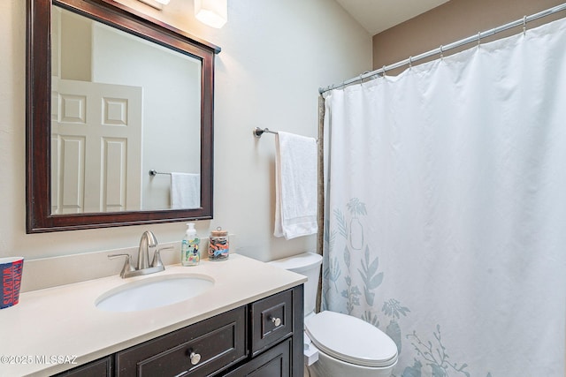 full bath featuring vanity and toilet
