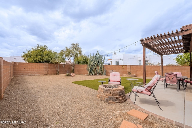 view of yard featuring a patio, a fenced backyard, a fire pit, and a pergola