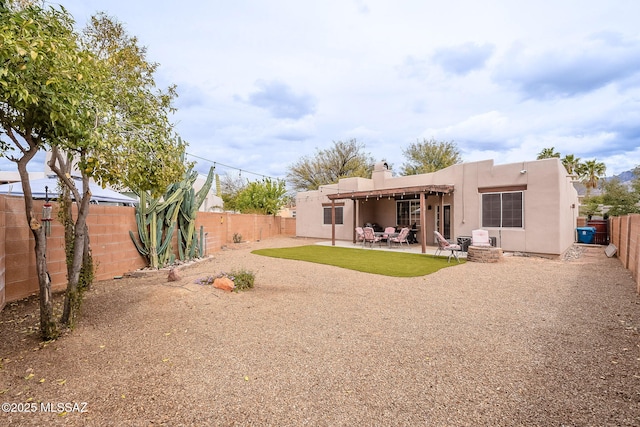 rear view of house featuring a fenced backyard, a patio area, stucco siding, and a chimney