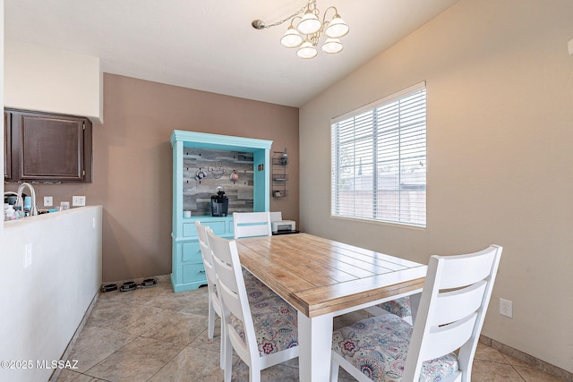 dining room featuring light tile patterned floors and a chandelier