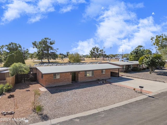 4362 E Ln Cienega St, Tucson, AZ 85712 - view of front of property featuring brick siding, fence, driveway, and a carport