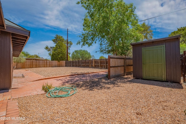 4362 E Ln Cienega St, Tucson, AZ 85712 - view of yard featuring an outdoor structure, a fenced backyard, a shed, and a patio