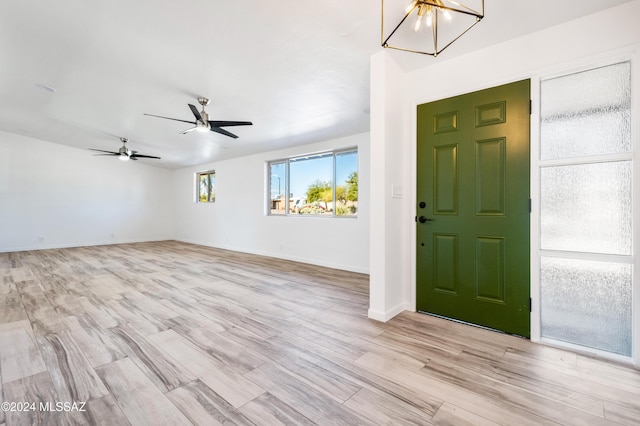 4362 E Ln Cienega St, Tucson, AZ 85712 - foyer with baseboards, ceiling fan with notable chandelier, and light wood-type flooring