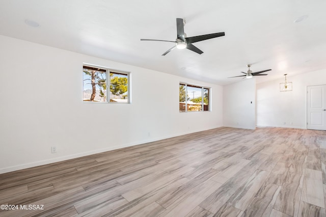 4362 E Ln Cienega St, Tucson, AZ 85712 - unfurnished living room featuring visible vents, baseboards, ceiling fan, and light wood-type flooring