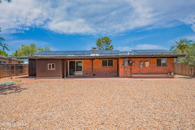 4362 E Ln Cienega St, Tucson, AZ 85712 - rear view of house with solar panels, a fenced backyard, and a patio area
