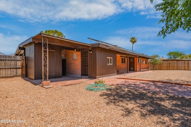 4362 E Ln Cienega St, Tucson, AZ 85712 - rear view of house with a fenced backyard and a patio area
