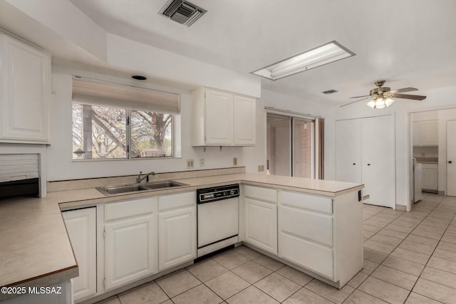 kitchen with a sink, light countertops, a peninsula, and dishwasher