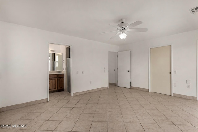 empty room with a ceiling fan, baseboards, visible vents, and light tile patterned floors