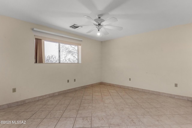 spare room with a ceiling fan, baseboards, and light tile patterned floors