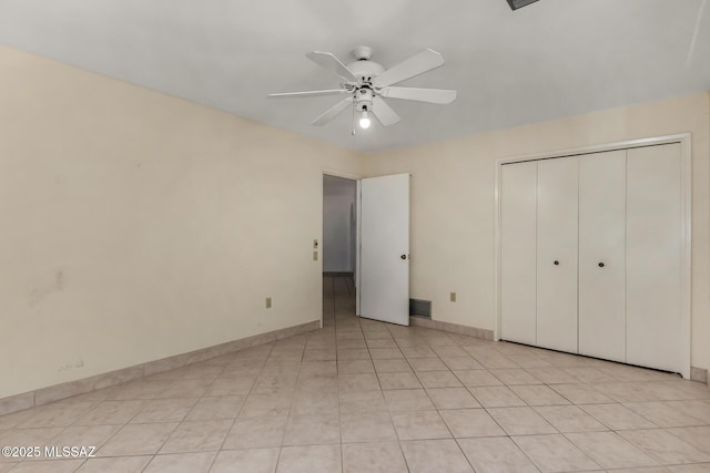 unfurnished bedroom featuring baseboards, a ceiling fan, a closet, and visible vents