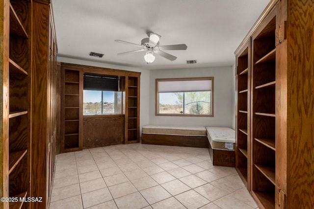 spare room with visible vents, a ceiling fan, and plenty of natural light