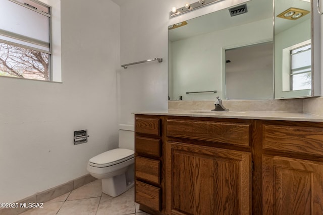 bathroom with tile patterned flooring, visible vents, vanity, toilet, and baseboards