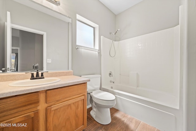 full bath featuring toilet, shower / tub combination, wood finished floors, and vanity