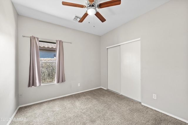 unfurnished bedroom with visible vents, baseboards, carpet floors, and a closet