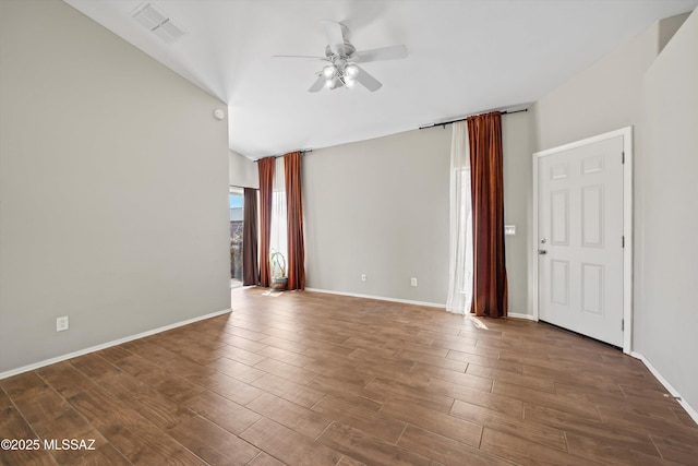 empty room featuring visible vents, wood finished floors, baseboards, a ceiling fan, and vaulted ceiling