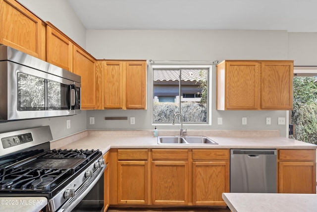 kitchen featuring light countertops, appliances with stainless steel finishes, and a sink