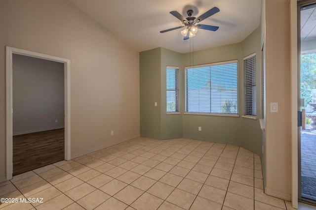 empty room featuring light tile patterned floors, baseboards, and ceiling fan
