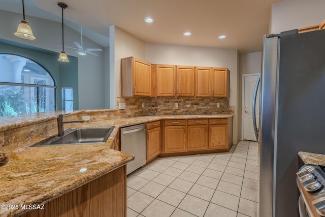 kitchen featuring light tile patterned floors, appliances with stainless steel finishes, a sink, and tasteful backsplash