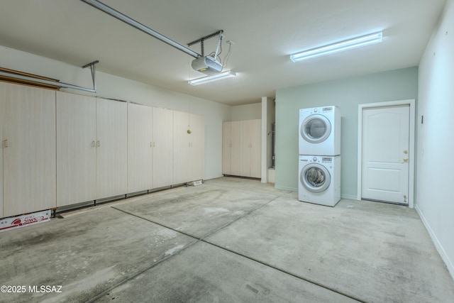 garage with stacked washer and dryer and a garage door opener