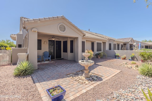 back of house with a patio, ceiling fan, fence, and stucco siding