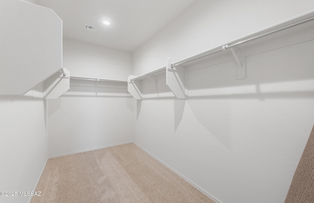 spacious closet with carpet floors and visible vents
