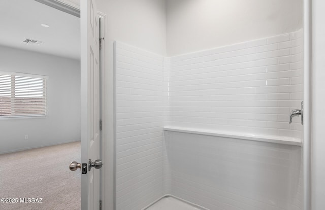 bathroom featuring a shower and visible vents