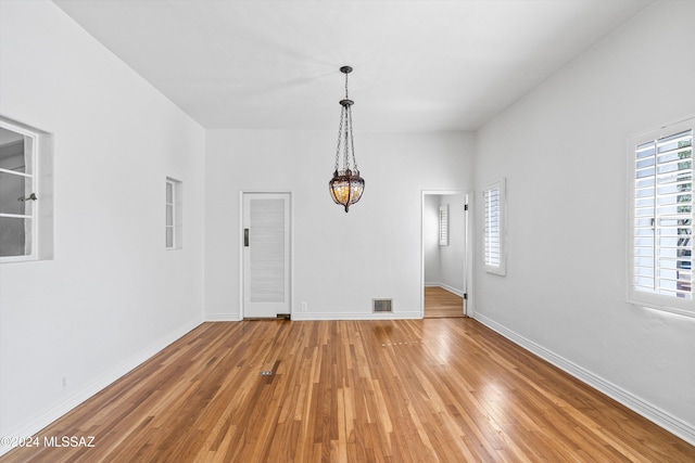 3263 E Broadway Blvd, Tucson, AZ 85716 - unfurnished dining area with light wood-type flooring, baseboards, and visible vents