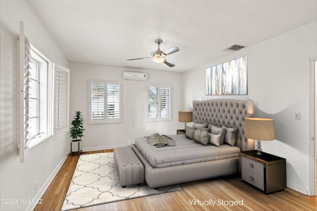 3263 E Broadway Blvd, Tucson, AZ 85716 - bedroom with visible vents, baseboards, light wood-style floors, ceiling fan, and a wall mounted AC