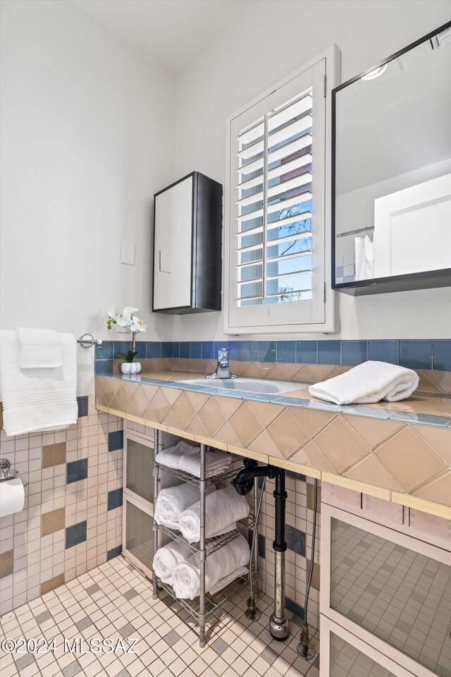 3263 E Broadway Blvd, Tucson, AZ 85716 - bathroom with tile walls, wainscoting, and a sink