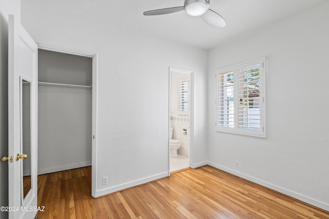 3263 E Broadway Blvd, Tucson, AZ 85716 - unfurnished bedroom featuring a closet, baseboards, ceiling fan, light wood-type flooring, and ensuite bath