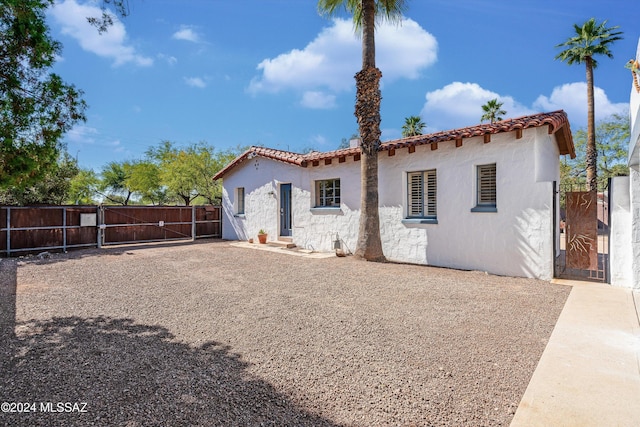 3263 E Broadway Blvd, Tucson, AZ 85716 - exterior space featuring fence, a gate, stucco siding, and a tile roof