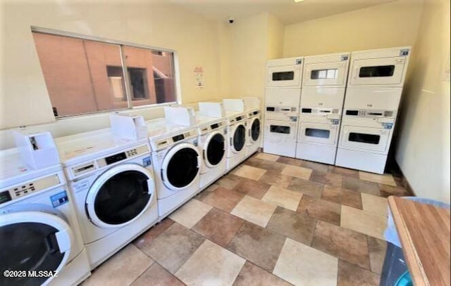 common laundry area with stone finish floor, washing machine and dryer, and stacked washer / dryer