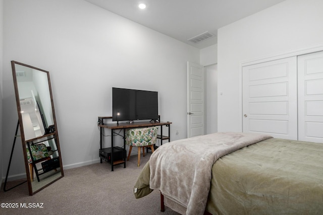 carpeted bedroom with a closet and baseboards