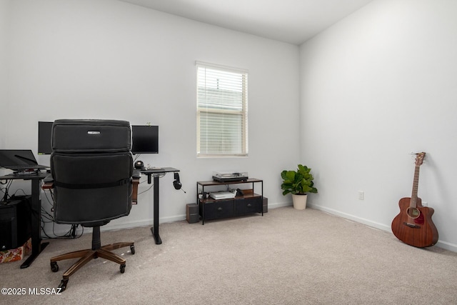 carpeted home office featuring baseboards