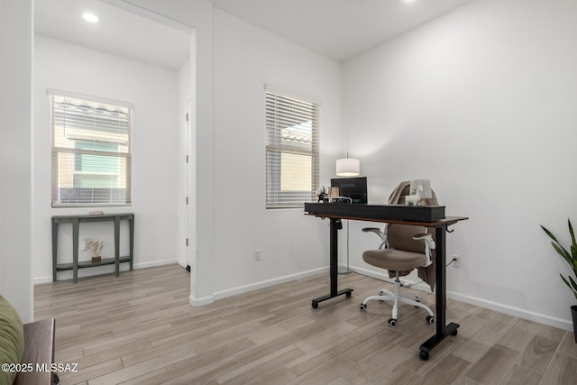 home office featuring light wood finished floors, plenty of natural light, baseboards, and recessed lighting