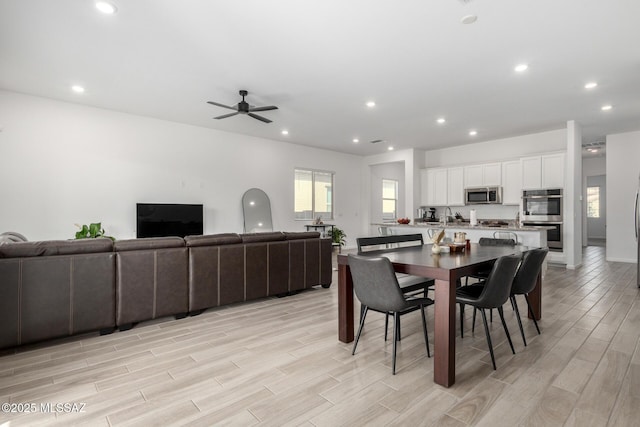 dining room featuring light wood-type flooring, ceiling fan, and recessed lighting