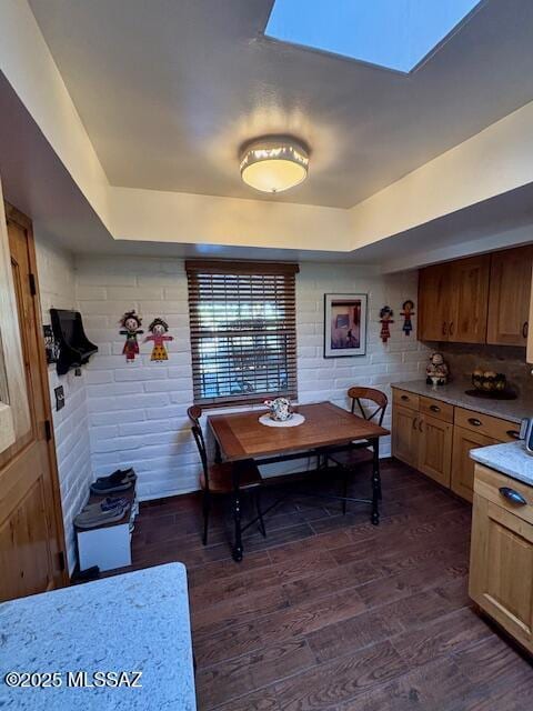 215 E Los Rincones, Green Valley, AZ 85614 - dining area featuring a raised ceiling, dark wood finished floors, and a skylight