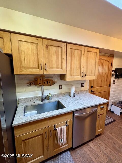 215 E Los Rincones, Green Valley, AZ 85614 - kitchen featuring light stone countertops, dishwasher, a sink, freestanding refrigerator, and dark wood-type flooring
