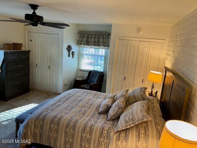 215 E Los Rincones, Green Valley, AZ 85614 - bedroom featuring two closets, a ceiling fan, a textured ceiling, and carpet