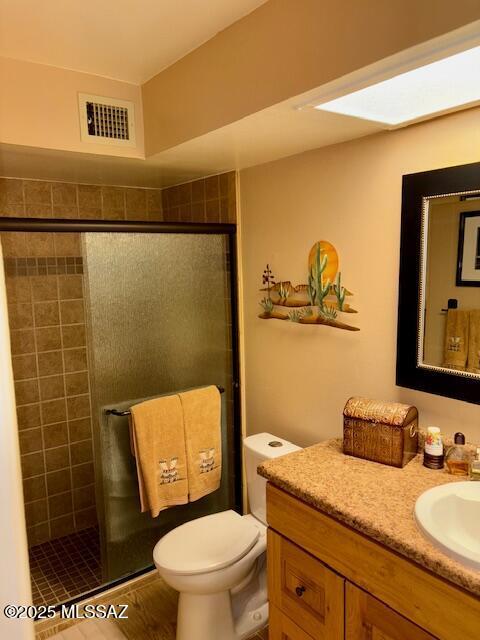 215 E Los Rincones, Green Valley, AZ 85614 - bathroom featuring visible vents, vanity, toilet, and a shower stall