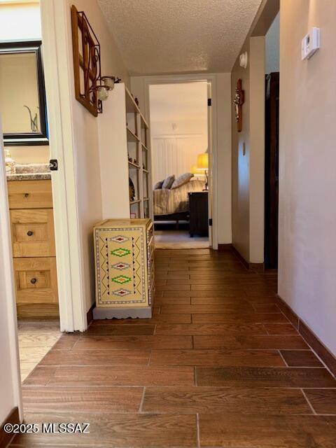 215 E Los Rincones, Green Valley, AZ 85614 - corridor featuring a textured ceiling and wood finished floors