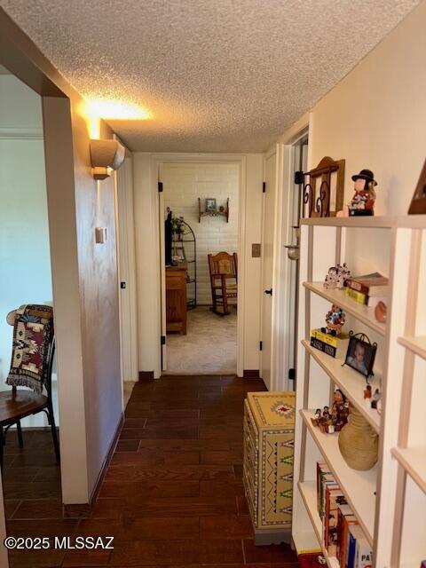 215 E Los Rincones, Green Valley, AZ 85614 - corridor featuring dark wood-type flooring and a textured ceiling