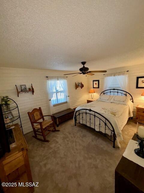 215 E Los Rincones, Green Valley, AZ 85614 - carpeted bedroom featuring a ceiling fan and a textured ceiling