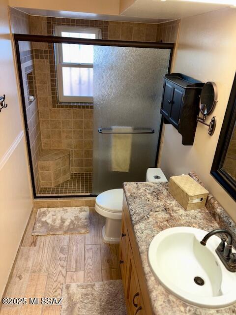 215 E Los Rincones, Green Valley, AZ 85614 - bathroom with vanity, toilet, wood finished floors, and a stall shower