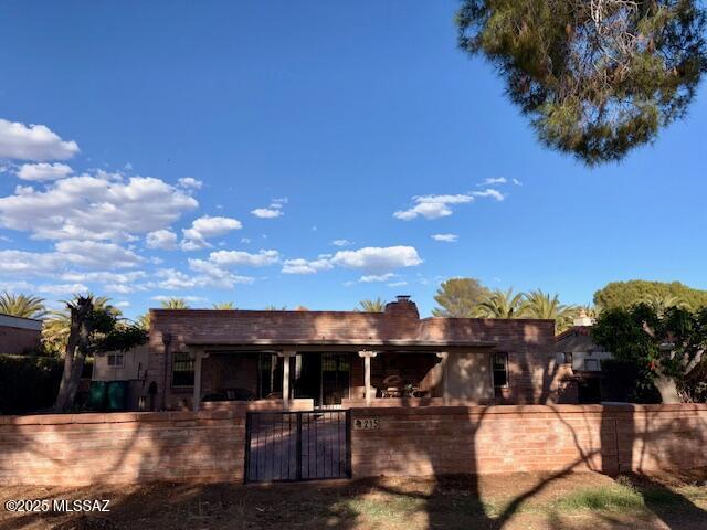 215 E Los Rincones, Green Valley, AZ 85614 - rear view of property with a gate, a fenced front yard, and a chimney
