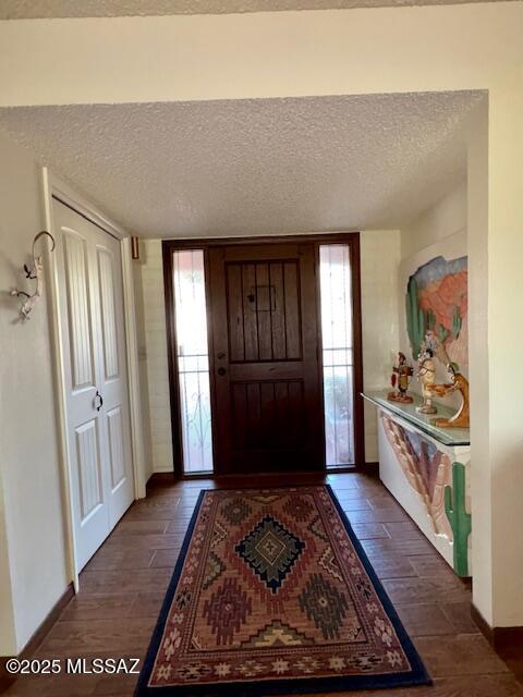 215 E Los Rincones, Green Valley, AZ 85614 - entryway with baseboards, a textured ceiling, and dark wood-style flooring