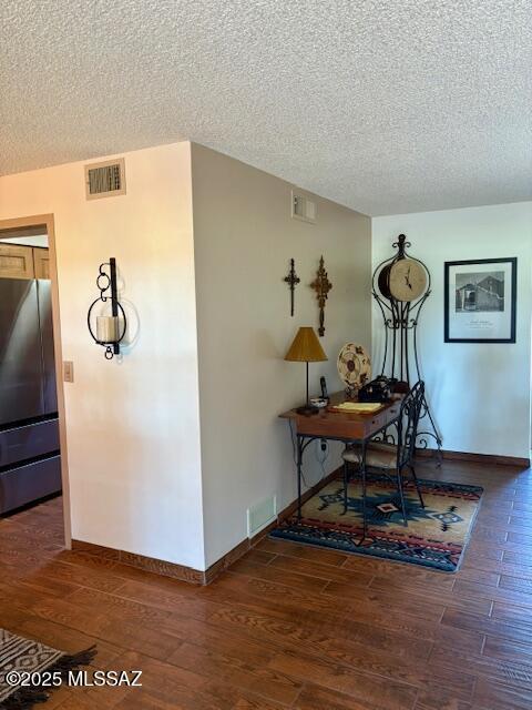 215 E Los Rincones, Green Valley, AZ 85614 - hallway with visible vents, baseboards, a textured ceiling, and wood finished floors
