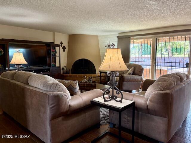 215 E Los Rincones, Green Valley, AZ 85614 - living room with a healthy amount of sunlight, dark wood finished floors, and a textured ceiling